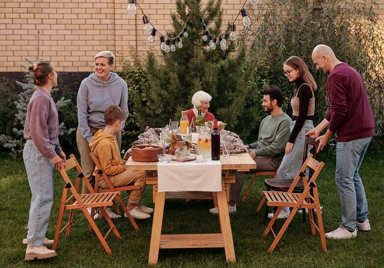 Family around outdoor picnic table image