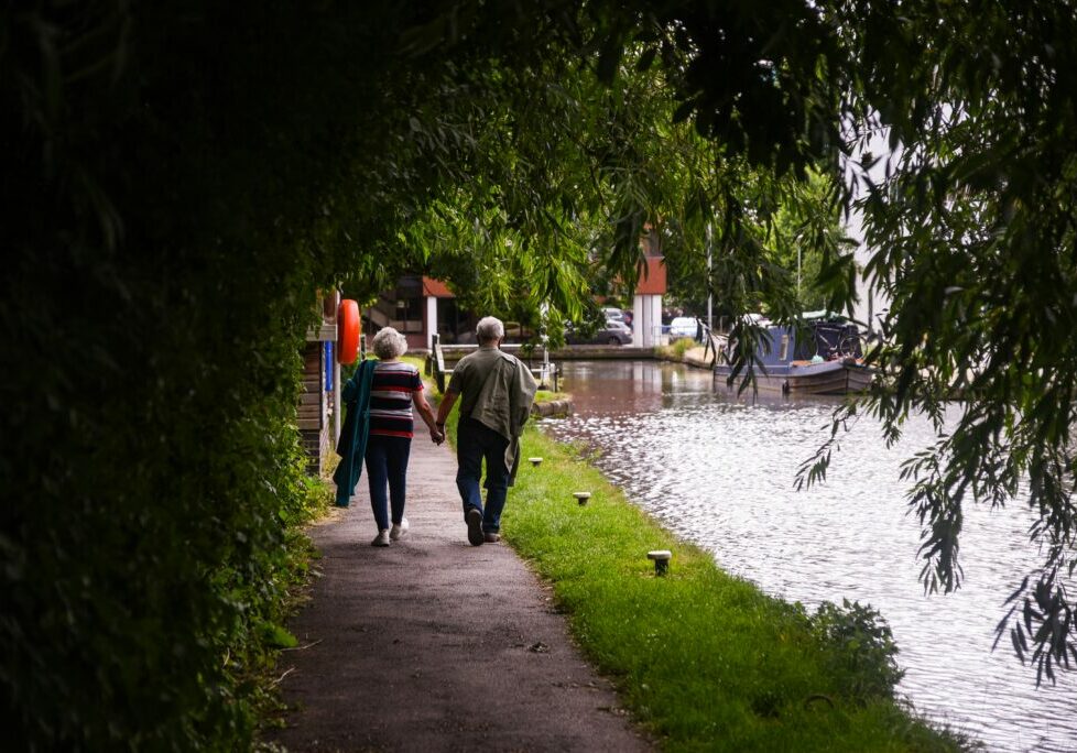 Couple holding hands by the water