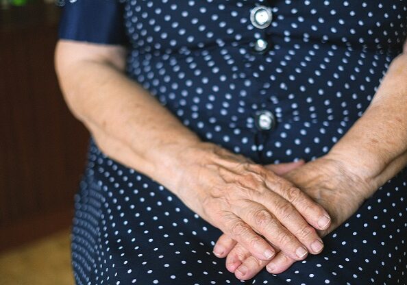 Old woman with hands across lap