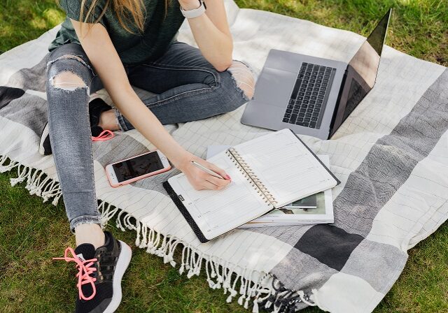 Girl in Park Studying with Computer